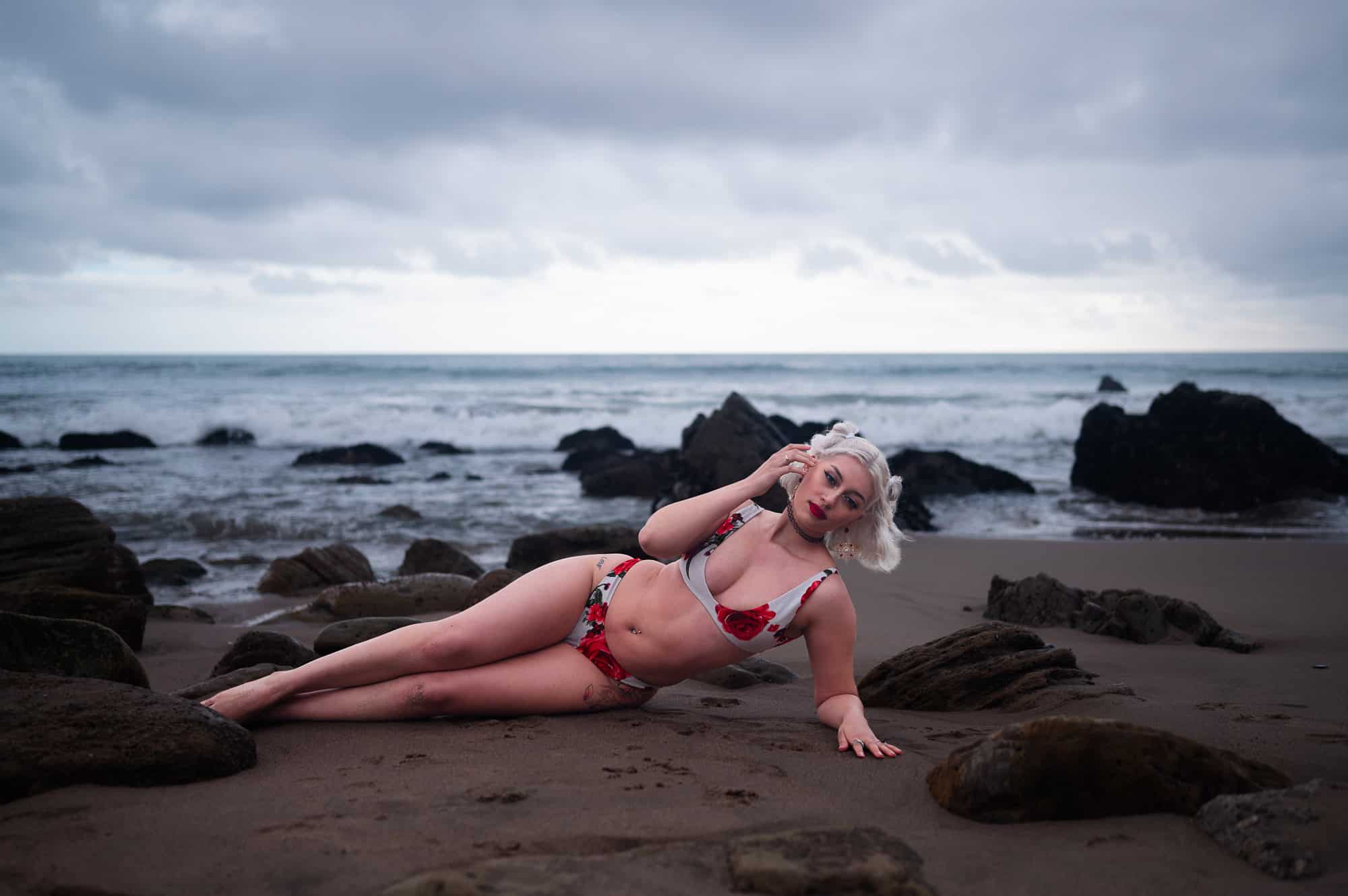 Sitting Beach Boudoir photography in a red and white bikini at El Matador in Los Angeles by Eli Boudoir