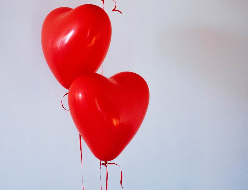 three red heart balloons