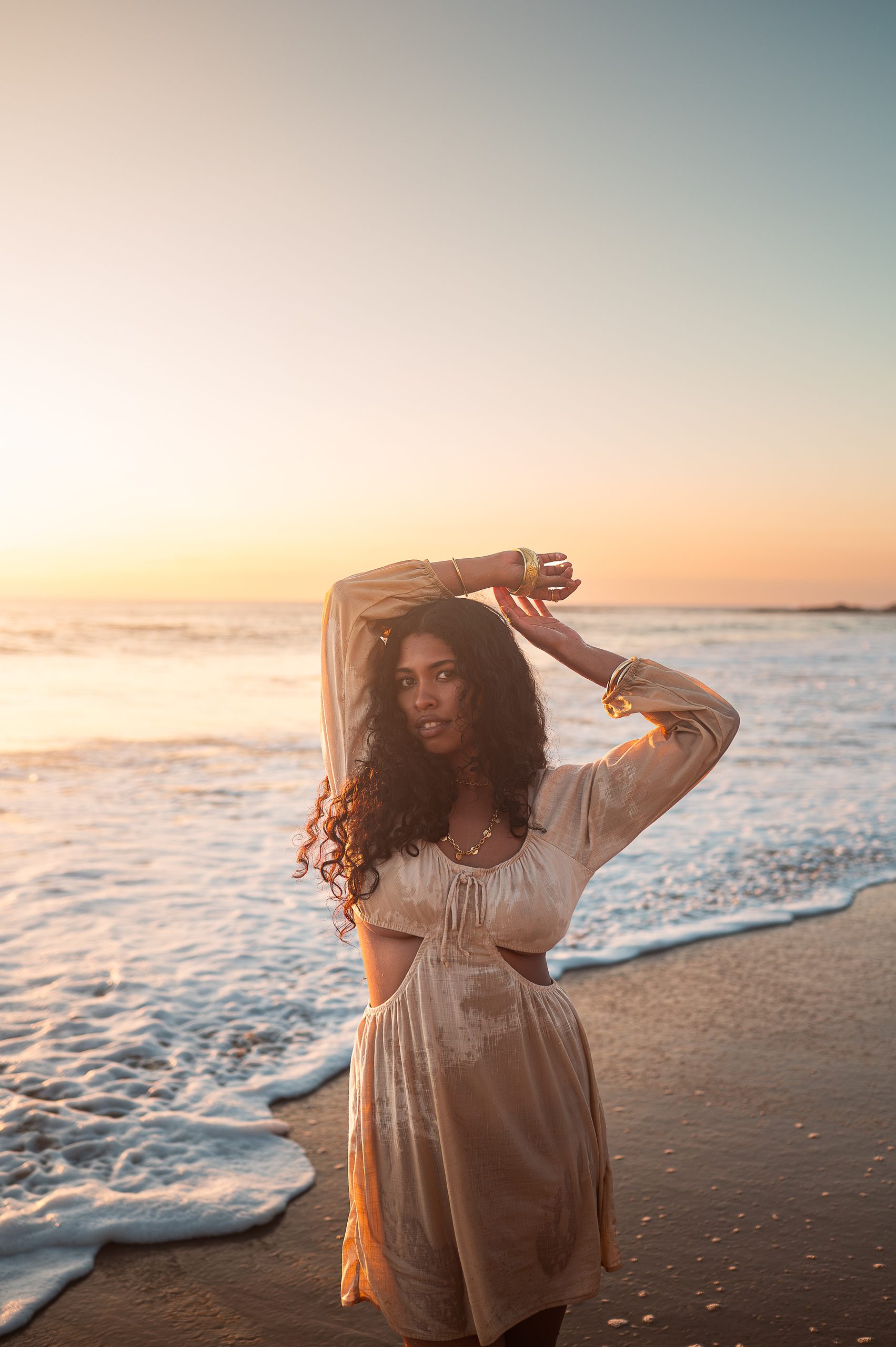 beach boudoir photograph in a tan slip dress.