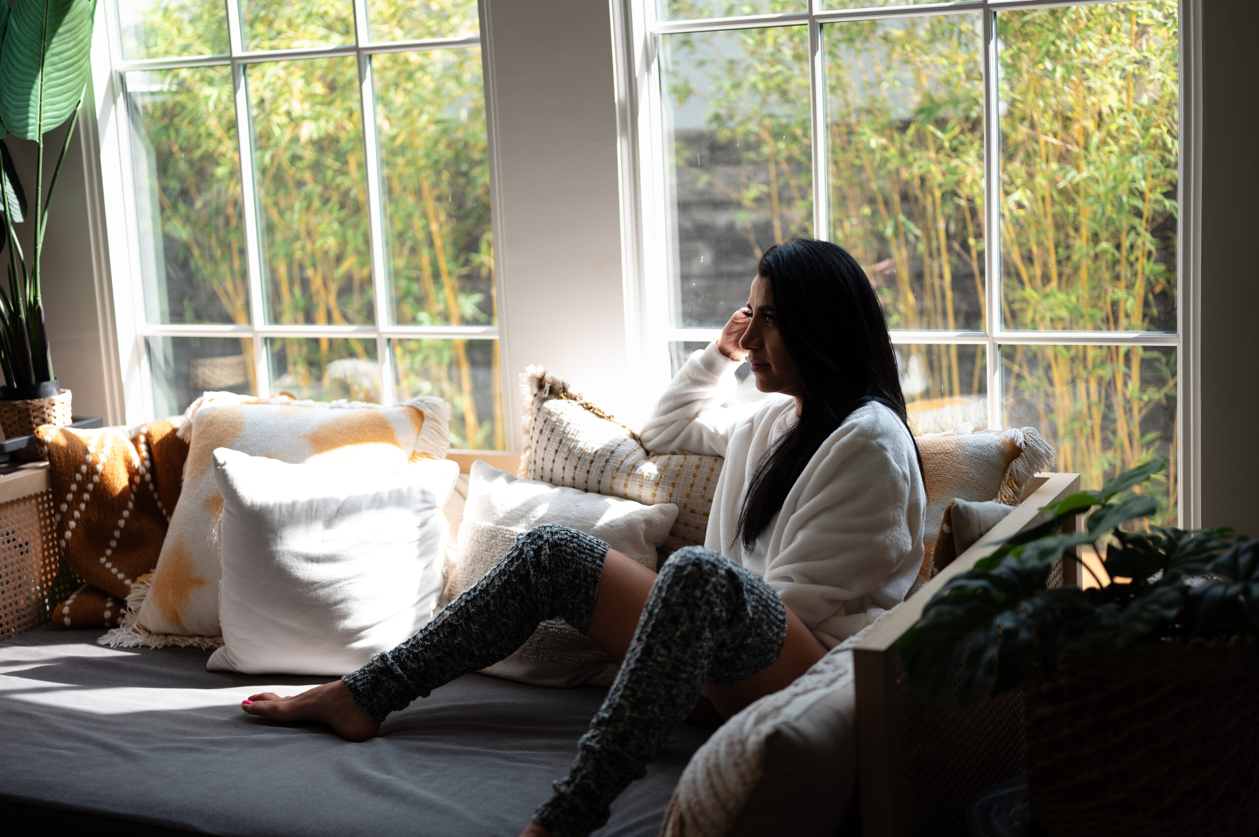 Best boudoir photographer in Los Angeles, Elili with ELI Boudoir. This photograph is of a beautiful woman sitting on a day bed.
