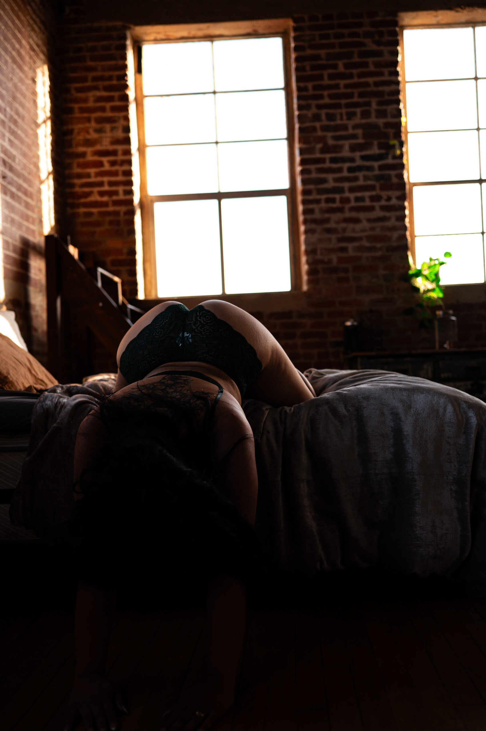 showcasing boudoir poses on a bed by ELI Boudoir. 